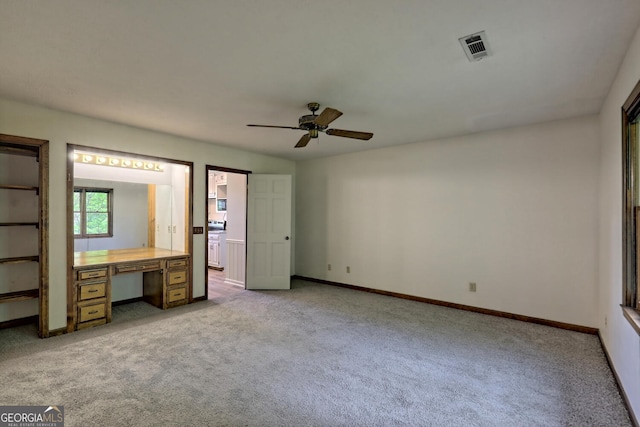 unfurnished bedroom with ceiling fan and light carpet