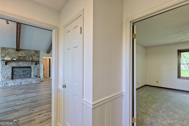 hallway with lofted ceiling with beams