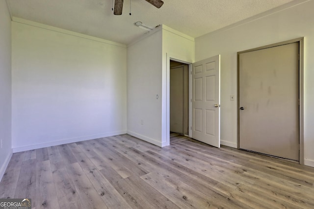 unfurnished bedroom with a textured ceiling, ceiling fan, and light hardwood / wood-style floors