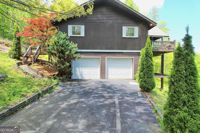 view of side of home with a garage and a wooden deck