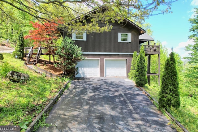 view of front of home with a garage and a wooden deck