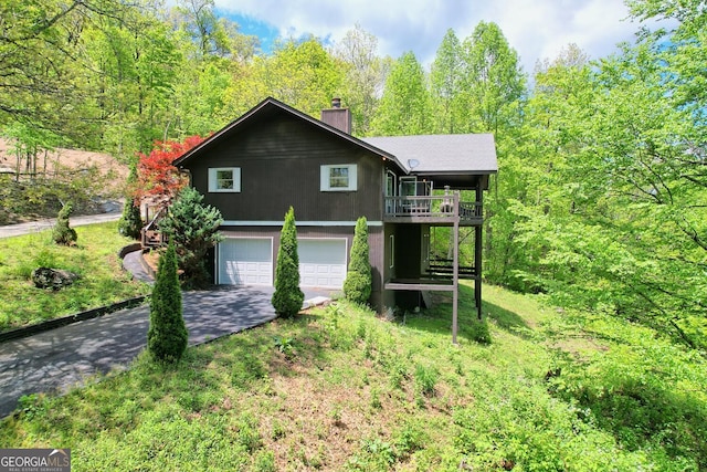 view of front of home with a garage and a front lawn