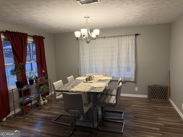 home office with ceiling fan with notable chandelier, dark hardwood / wood-style flooring, and a textured ceiling