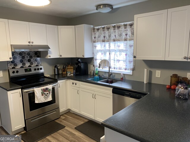 kitchen with a textured ceiling, stainless steel appliances, white cabinetry, and dark hardwood / wood-style floors