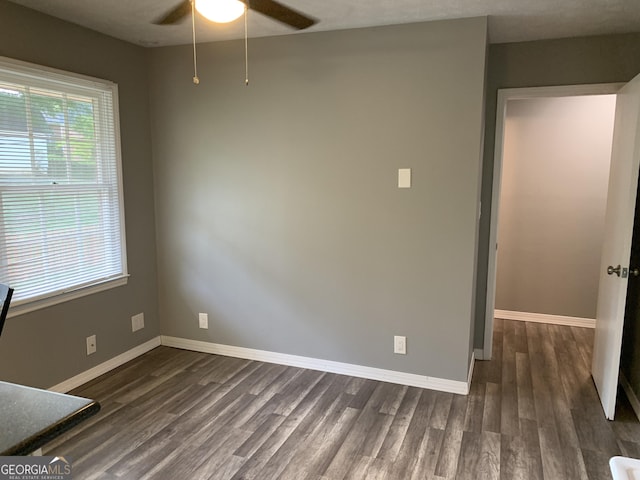 unfurnished room featuring ceiling fan, dark hardwood / wood-style flooring, and a textured ceiling