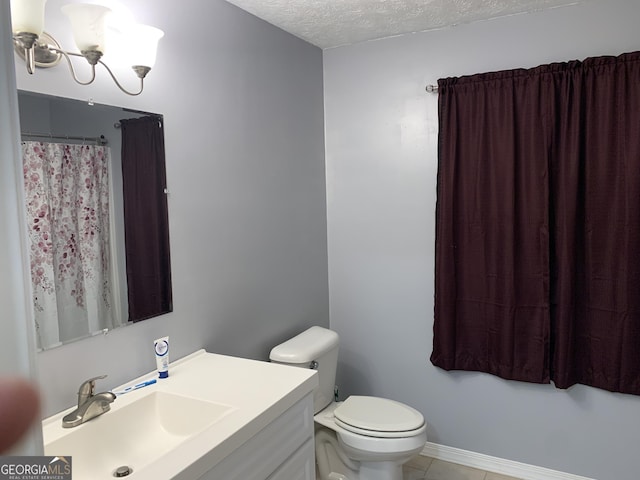 bathroom featuring vanity, tile patterned flooring, toilet, a textured ceiling, and a chandelier