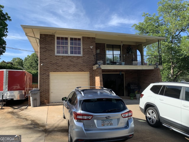 view of front facade featuring a garage and a balcony