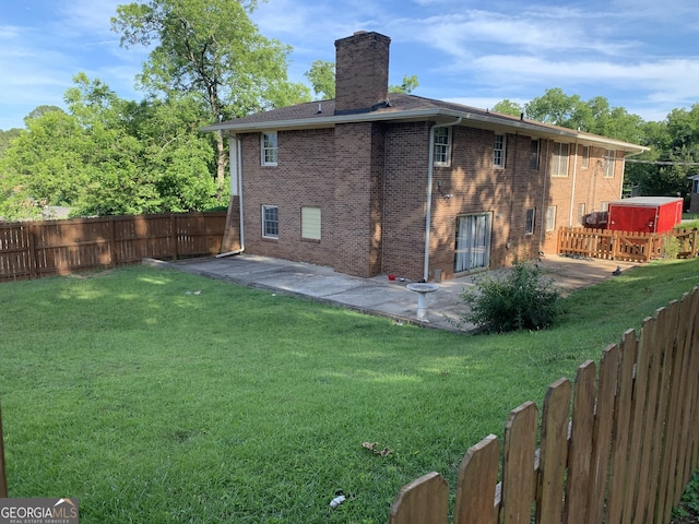 rear view of property featuring a patio area and a lawn