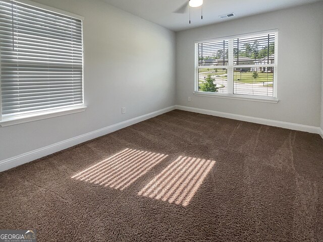 spare room featuring carpet flooring and ceiling fan