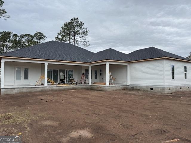 rear view of house featuring crawl space and french doors