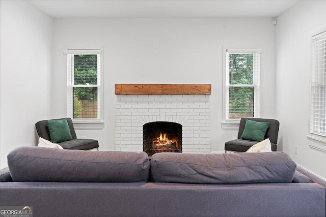 living room featuring a brick fireplace