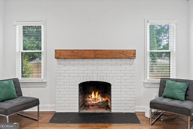 living area featuring dark wood-type flooring and a fireplace