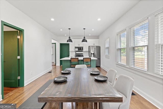 dining space with light hardwood / wood-style floors