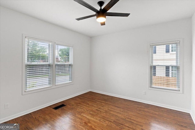 empty room featuring dark hardwood / wood-style flooring and ceiling fan