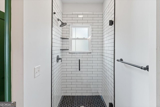 bathroom with a shower with shower door