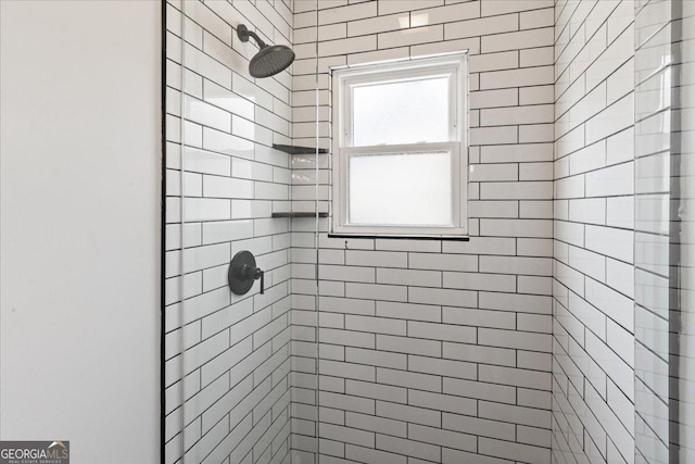 bathroom with a tile shower