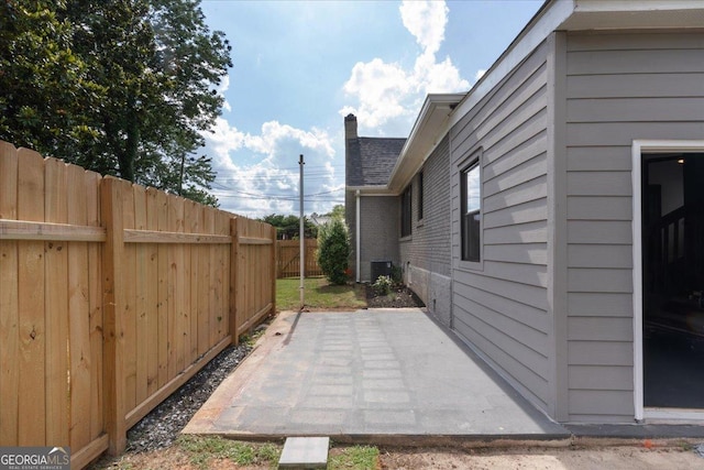 view of yard with cooling unit and a patio area