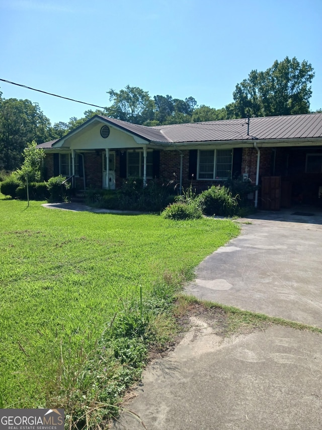 ranch-style house with a carport and a front yard