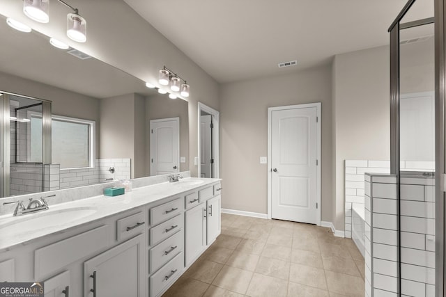 bathroom featuring tile patterned flooring, vanity, tasteful backsplash, and a bathtub