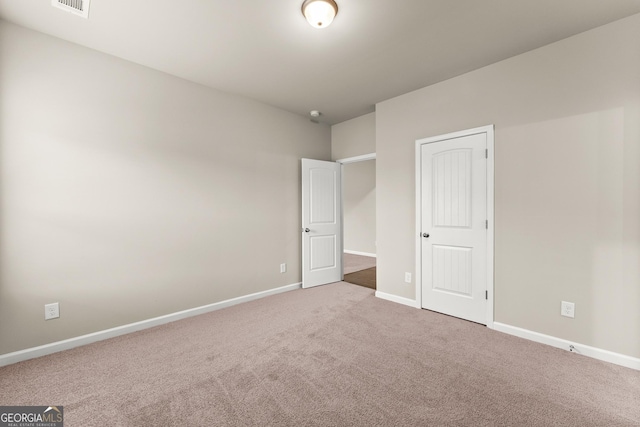 unfurnished bedroom featuring carpet flooring and a closet