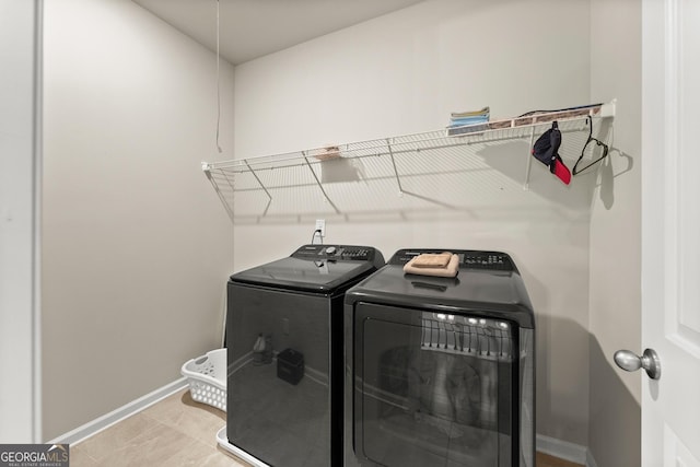 washroom with independent washer and dryer and light tile patterned floors