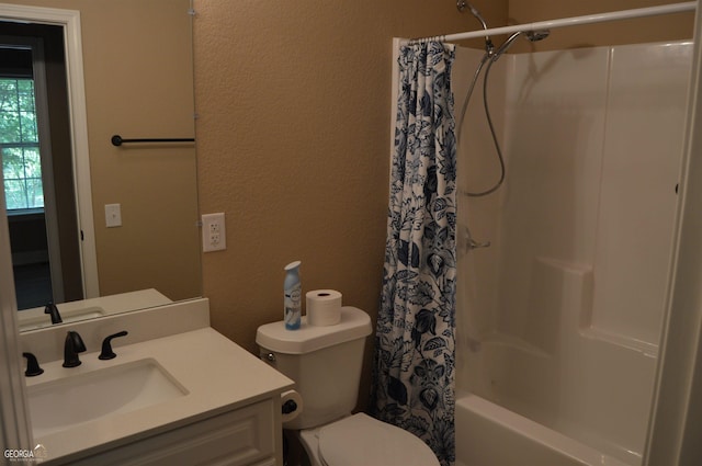 full bathroom with vanity, shower / bath combo with shower curtain, and toilet