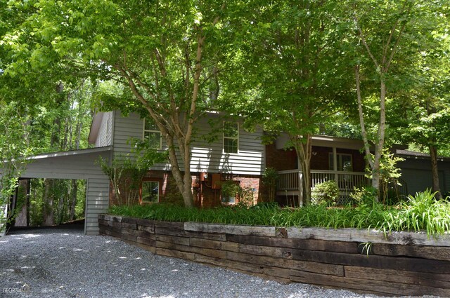 obstructed view of property with a carport