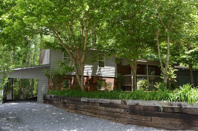 view of front of home with a carport and a porch