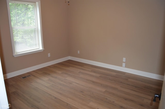 spare room with wood-type flooring