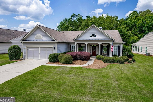 view of front of home with a garage and a front lawn