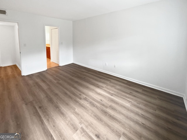 unfurnished bedroom with dark wood-type flooring