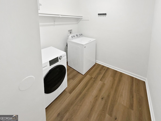 washroom featuring hardwood / wood-style floors and washer and clothes dryer