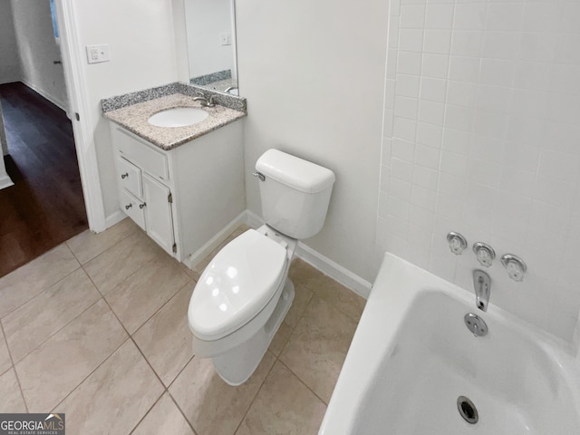 bathroom with tile patterned flooring, vanity, and toilet