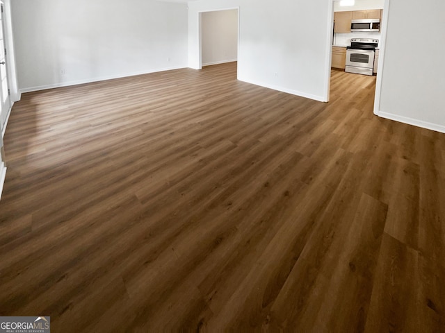 unfurnished living room featuring dark hardwood / wood-style floors