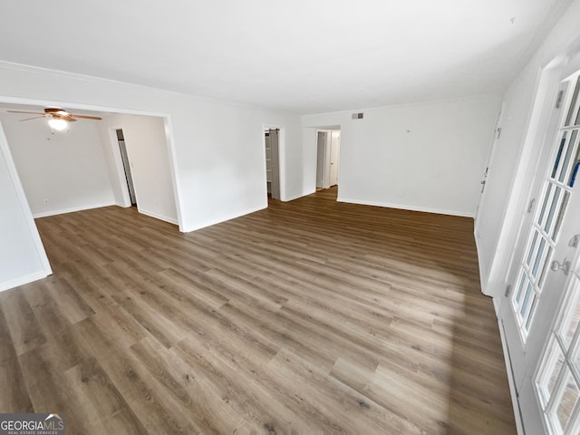 empty room featuring ceiling fan and dark hardwood / wood-style floors