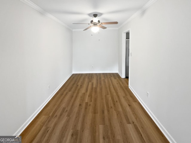 unfurnished room with dark hardwood / wood-style flooring, ceiling fan, and crown molding