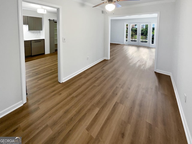 unfurnished room featuring dark hardwood / wood-style floors, ceiling fan, ornamental molding, and french doors