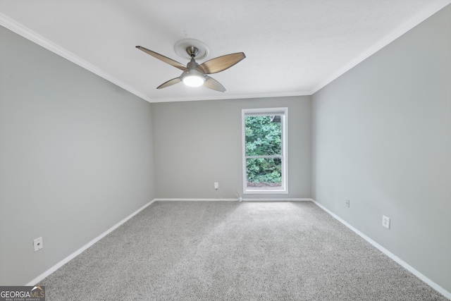 spare room featuring crown molding, ceiling fan, and carpet