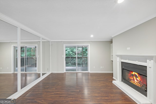 unfurnished living room with crown molding and dark hardwood / wood-style floors