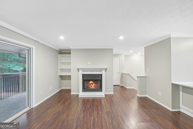 unfurnished living room featuring dark hardwood / wood-style floors and crown molding