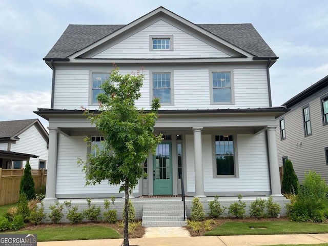 greek revival inspired property featuring a porch