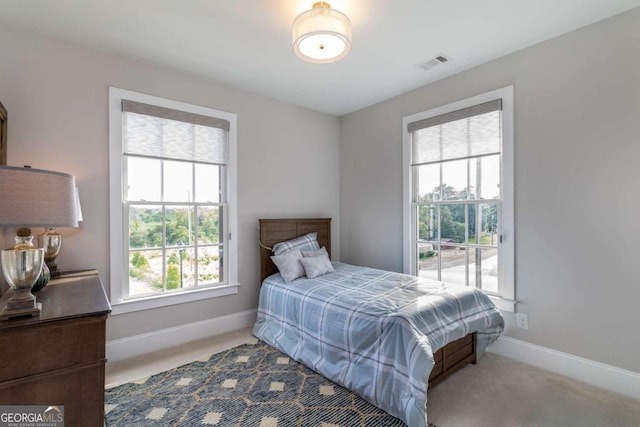 bedroom featuring light carpet