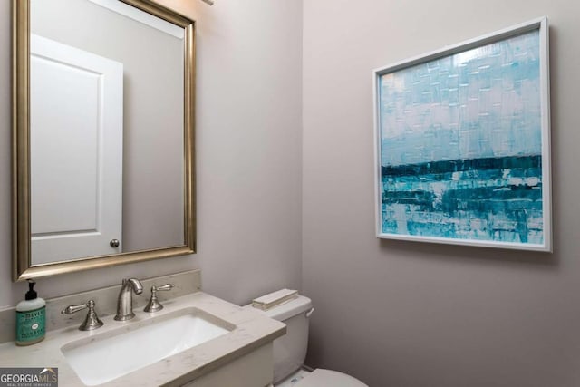 bathroom featuring vanity and toilet