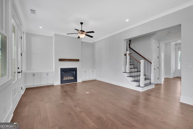 unfurnished living room featuring crown molding, light hardwood / wood-style floors, and ceiling fan