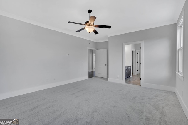 unfurnished bedroom featuring light carpet, connected bathroom, multiple windows, and ceiling fan