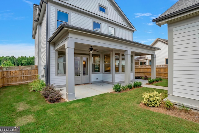 rear view of property featuring a patio, ceiling fan, and a lawn