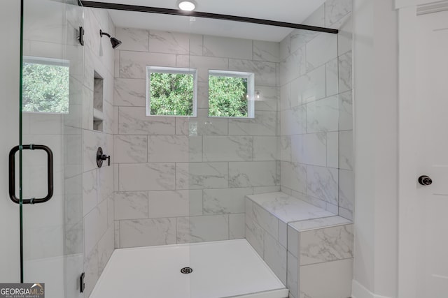 bathroom featuring a shower with door