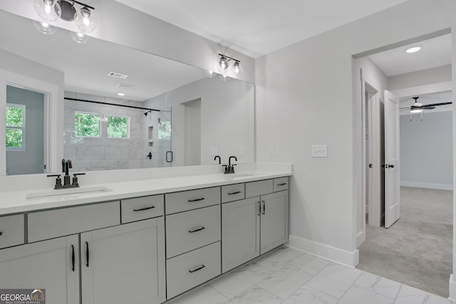 bathroom with vanity, ceiling fan, and an enclosed shower