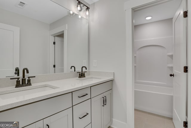 bathroom with vanity, a tub to relax in, and tile patterned floors