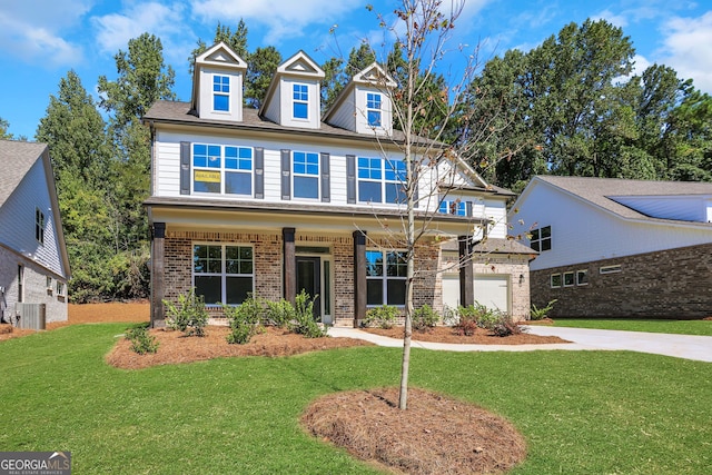 view of front of house featuring a front lawn, central AC, and covered porch